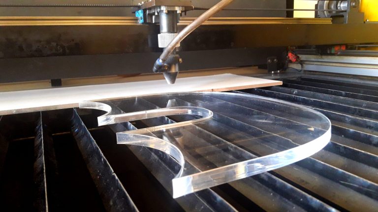CNC router cutting an acrylic piece