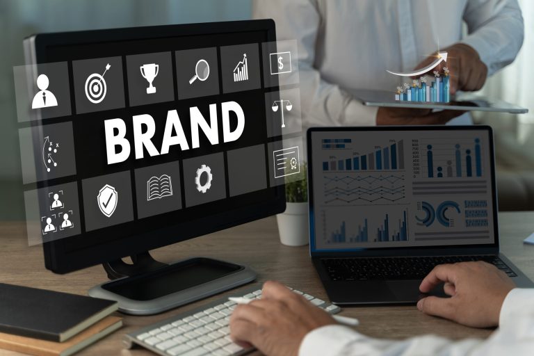 Workstation showing the word brand on screen alongside analytics charts