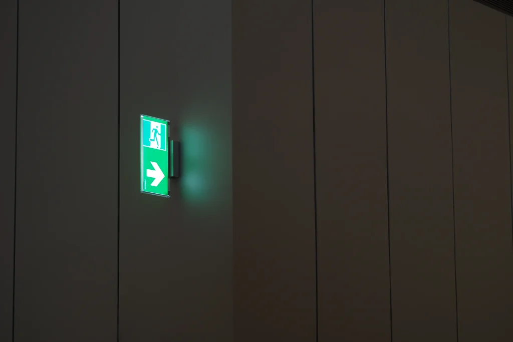 Señal luminosa de salida de emergencia en un pasillo
